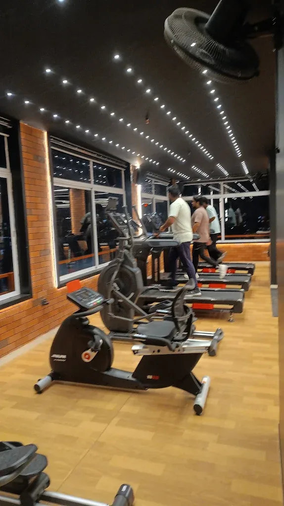 Exercise bike and cardio machines beside the windows