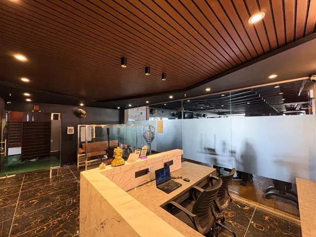 Wide view of the reception desk under a wooden slatted ceiling